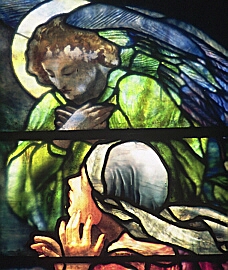 Detail from stained glass window by Tiffany Studios showing Mary Magdalene and an angel after Mary has just recognised Jesus after the Resurrection