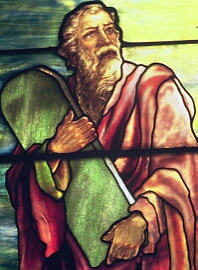 Stained glass depiction of Moses carrying a tablet by Tiffany Studios